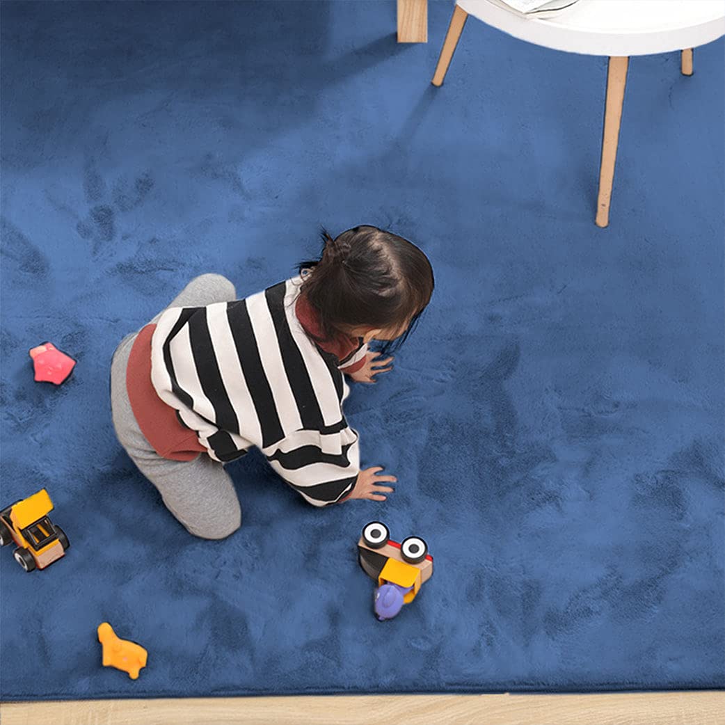 child_playing_on_a_blue_rabbit_fur_carpet