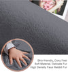 dark gray rabbit fur carpet with a close-up of a hand touching it