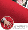 baby's hand touching maroon rabbit fur carpet for it's softness