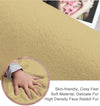 Close-up of a camel beige rabbit fur carpet surface with a hand touching it