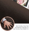 Close-up of brown rabbit fur carpet with a hand touching it, highlighting its texture and softness.