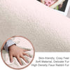 Close-up of a soft, plush ivory rabbit fur carpet with a hand touching it