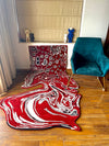 Boho-chic living room with red Persian melting rug as a wall hanging
