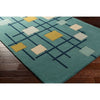 Detailed view of hand tufted wool texture in teal, yellow, and white tones