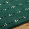 Edge stitching and finish of premium hand tufted green rug