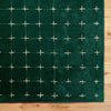 Detailed view of white grid pattern on plush green wool rug