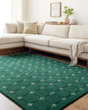 Emerald green geometric wool rug in a modern living room with cream sofa