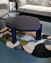 bstract multicolor hand tufted rug under modern navy coffee table