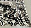 20mm thick hand-tufted wool rug with abstract melting pattern.
