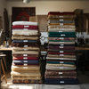 stacked_labeled_rugs_in_natural_lighting