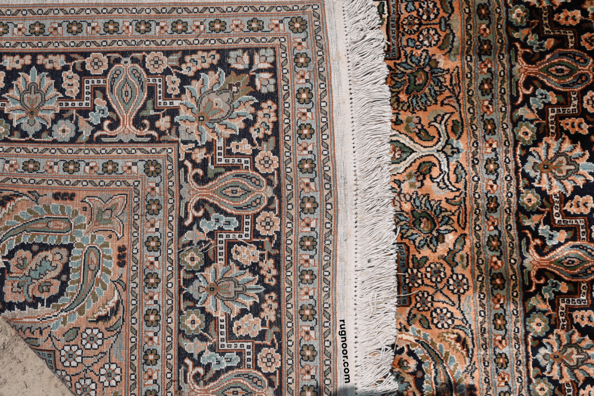 Persian heritage rug folded to show natural woven back versus front pattern — hand-knotted construction detail 