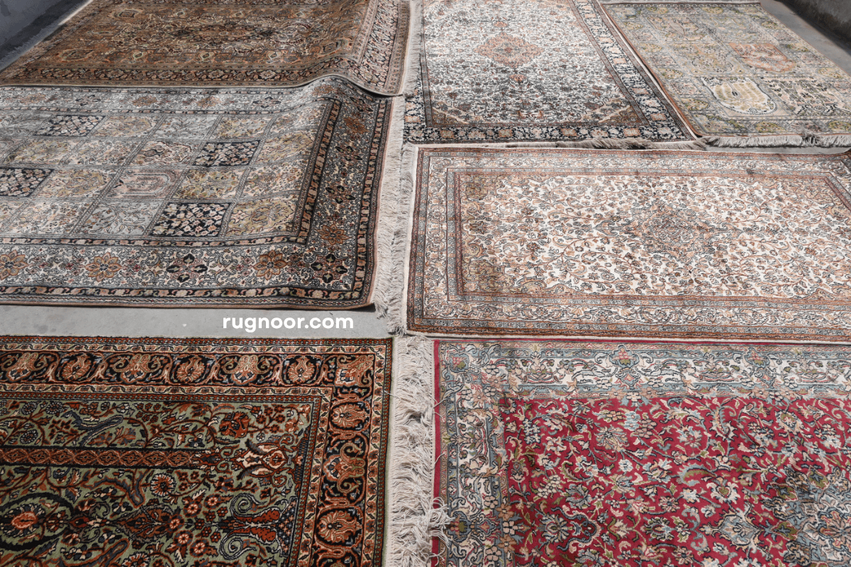 Multiple Persian heritage rugs laid flat showing full colour range including red, ivory, green and blue designs — Rugnoor Persian Heritage Collection