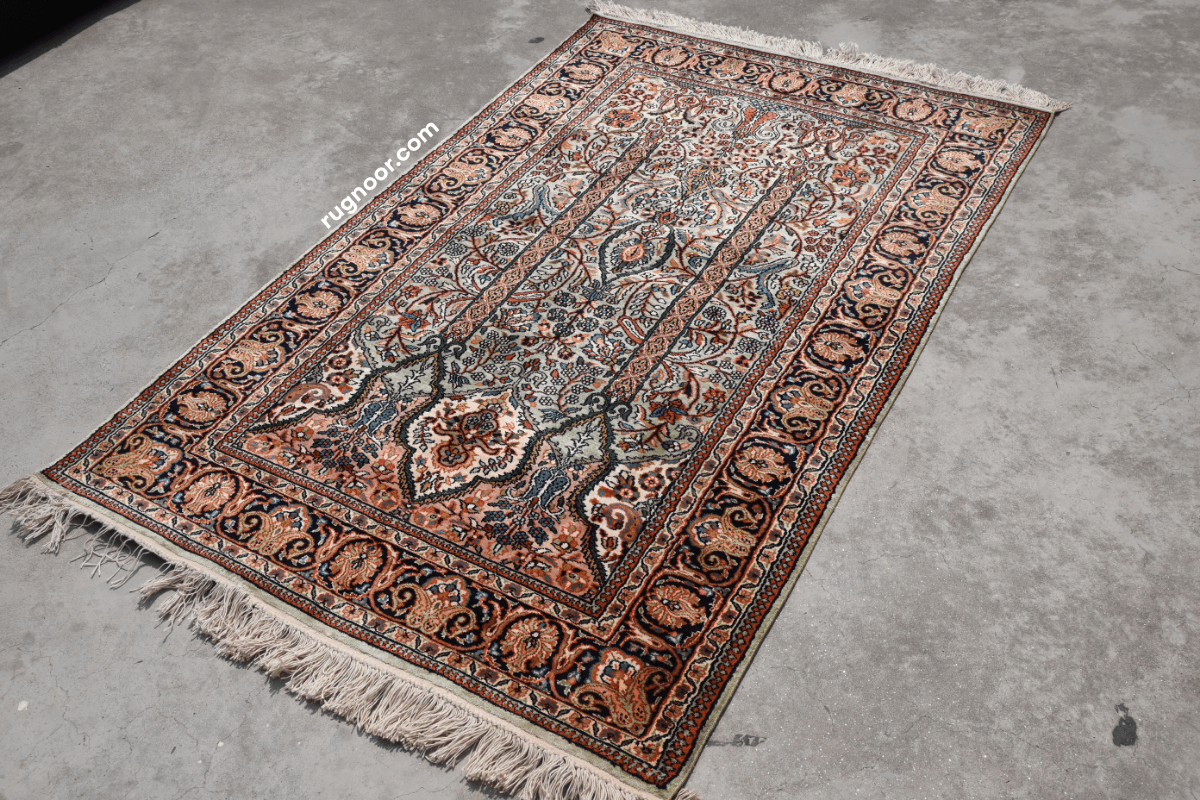 Full view of Persian heritage rug with ivory ground, central medallion and rich dark floral border — timeless design from the Rugnoor collection