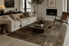 Contemporary living room styled with a Persian heritage patchwork rug featuring muted terracotta, sage, and ivory tones beneath modern minimalist furniture