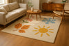 Hand-tufted seasonal rug displayed in a cozy living room, featuring artistic motifs of autumn leaves, spring blossoms, summer sun, and winter snowflakes, symbolizing year-round inspiration.