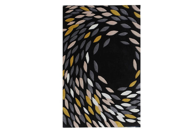 A rectangular area rug with a black background and an abstract spiral pattern made of leaf-like shapes in white, gray, beige, and mustard yellow, shown flat against a white background.