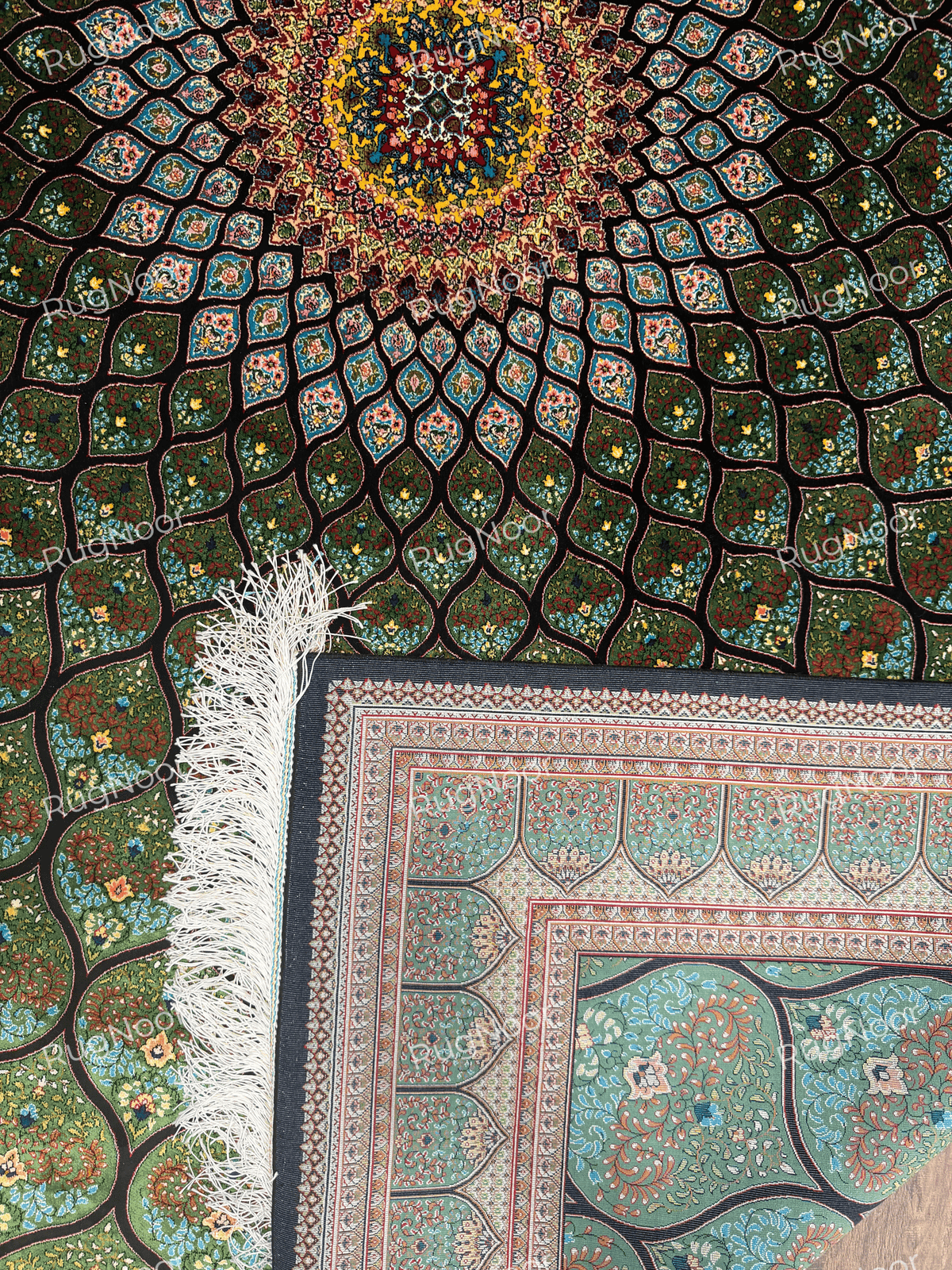 Tawus carpet corner showing the black edge, white fringe and layered decorative borders.