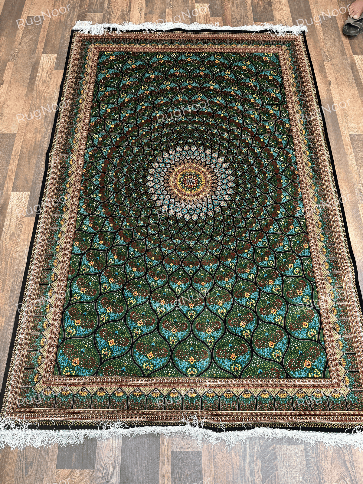 Full overhead view of Tawus carpet displaying its symmetrical green floral design and decorative borders.