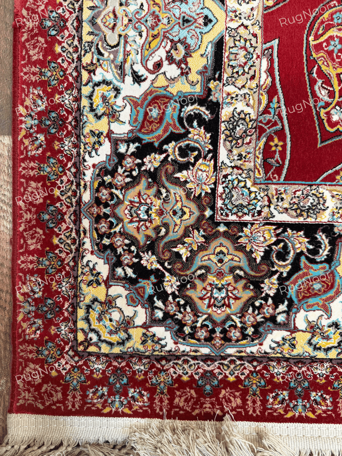 Close-up of the intricate central medallion in cream, blue, gold, and dark red