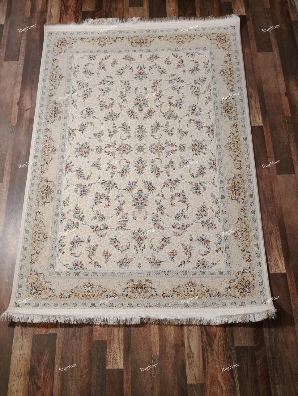 Full view of the Mehravi 5x7 ivory traditional carpet showing its symmetrical floral arrangement, cream ornamental border and decorative fringe.