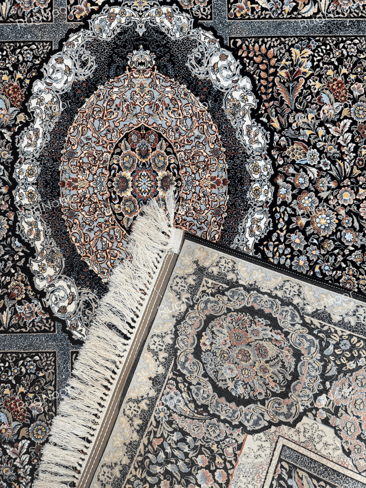 Central medallion detail with a folded corner showing the carpet backing and fringe by RugNoor