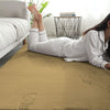 Person lying on a golden rabbit fur carpet in a room