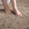 Feet standing on taupe rabbit fur carpet
