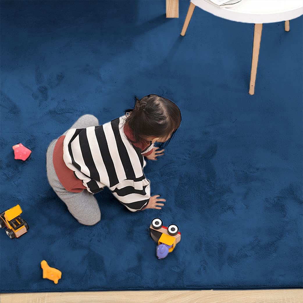 Child playing with toys on a blue rabbit fur carpet