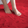 Maroon rabbit fur carpet with a person's feet standing on it