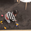 Child playing on a brown rabbit fur carpet with toys