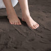 Feet standing on a brown rabbit fur carpet