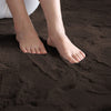 Brown rabbit fur rug with feet stepping onto it