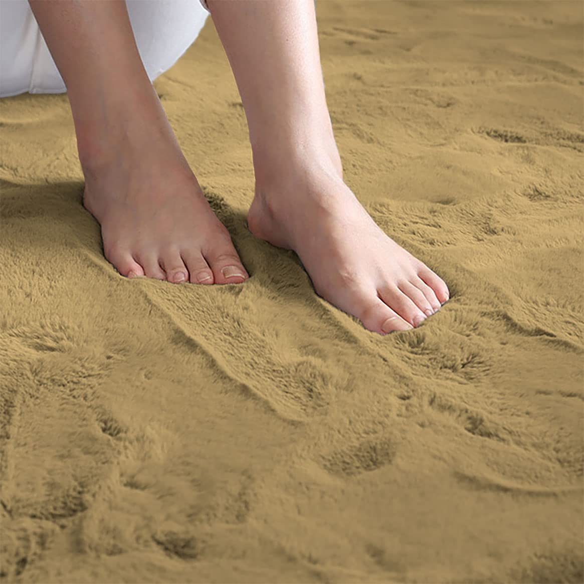 Feet standing on a golden camel rabbit fur carpet
