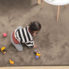 Child playing on a taupe rabbit fur carpet with toys