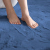 Blue rabbit fur carpet with feet stepping onto it