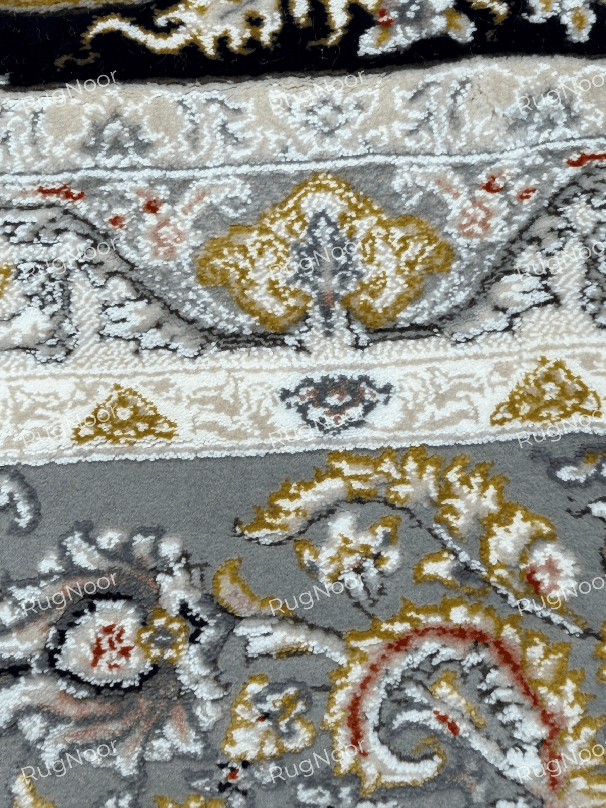 Close-up of Urkeed's layered ivory and grey border with gold and rust floral ornaments, RugNoor.