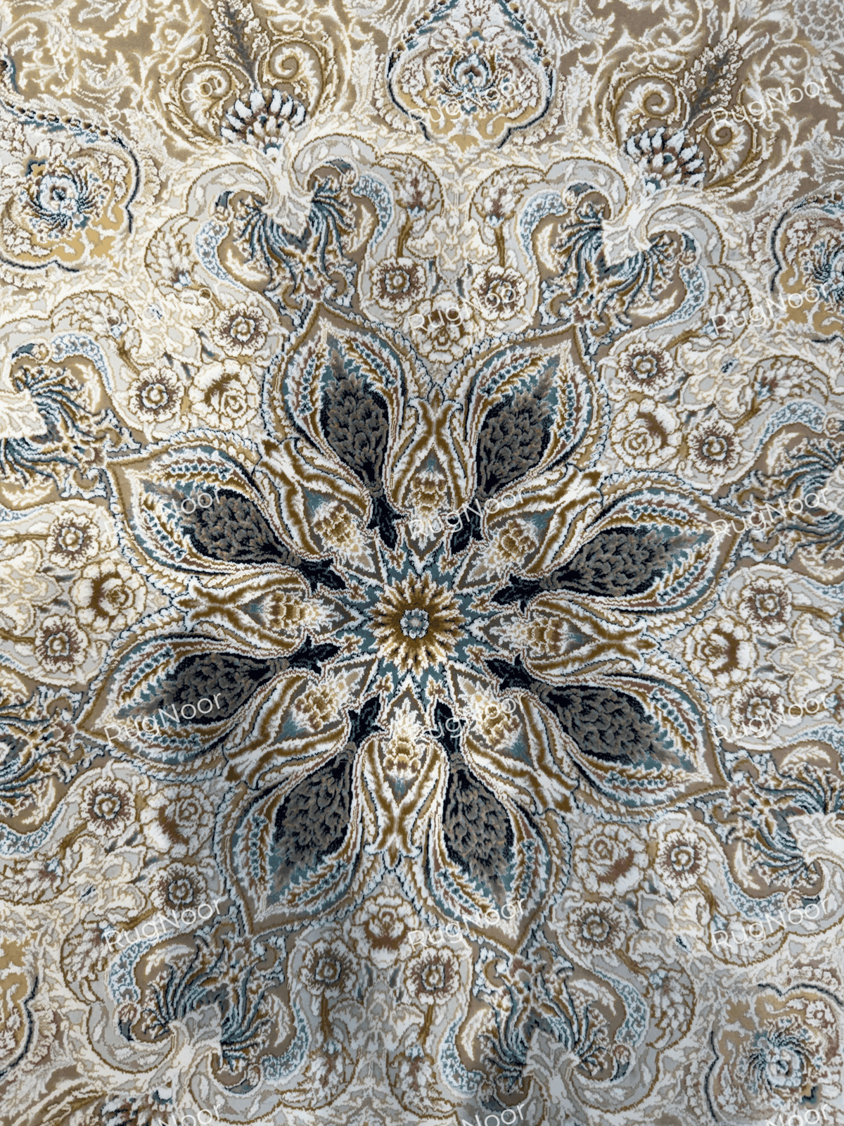 Detailed view of Warda's symmetrical flower-shaped medallion with dark grey and muted blue accents, RugNoor.