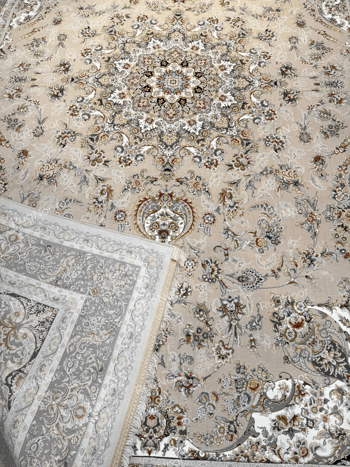 Folded corner of Urkeed rug revealing the carpet's underside alongside its beige floral surface, RugNoor.