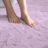 Person standing on a soft, light purple rabbit fur carpet