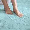 light blue rabbit fur carpet with feet standing on it