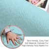 Close-up of a soft turquoise rabbit fur carpet with a child's hand touching it, highlighting its texture and comfort.