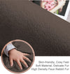 Brown rabbit fur carpet surface with a close-up of a hand touching it