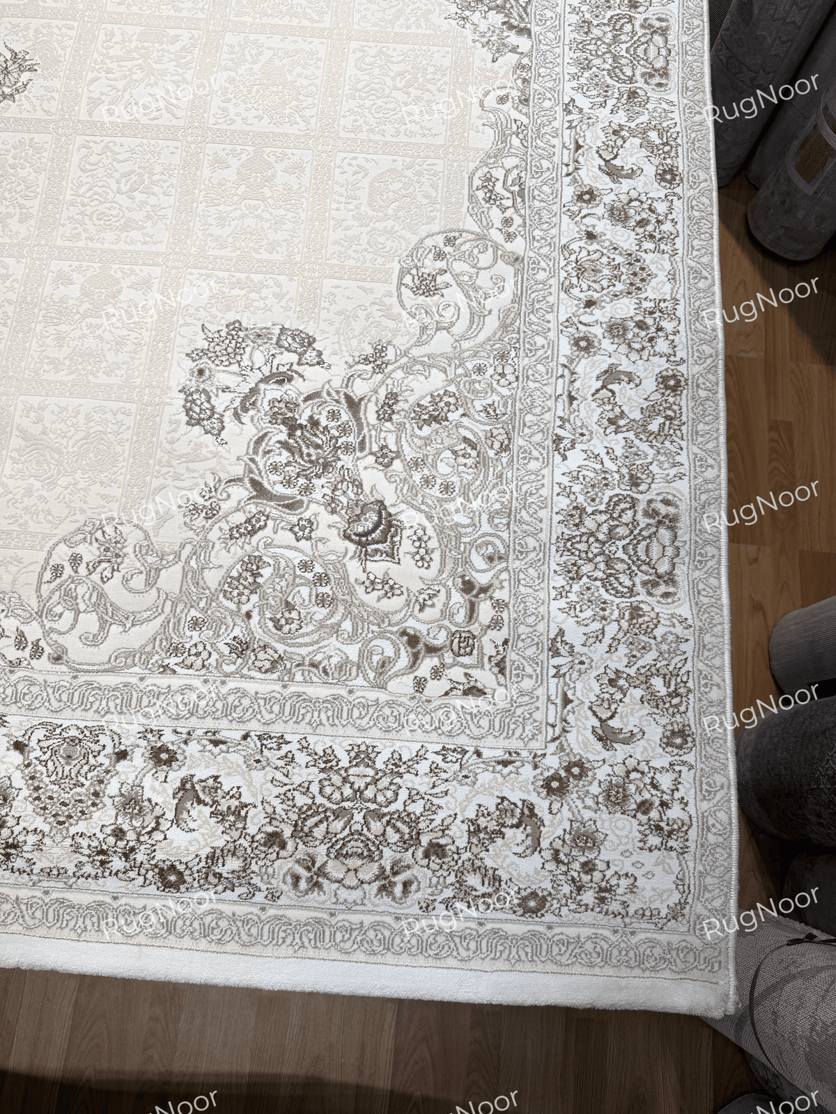 Dark taupe floral medallion against the ivory patterned field of the Parichehr carpet, RugNoor.