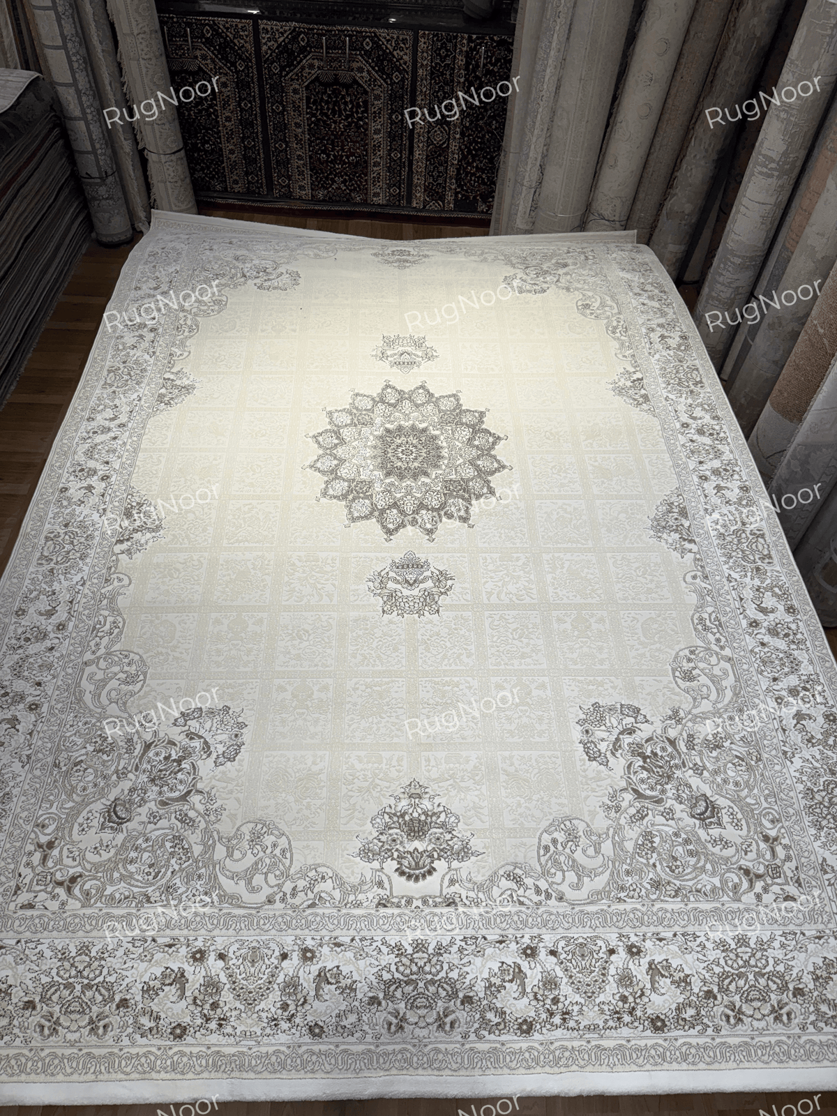 Alternate full view of Parichehr showing its ivory patchwork field, central medallion and detailed perimeter border, RugNoor.