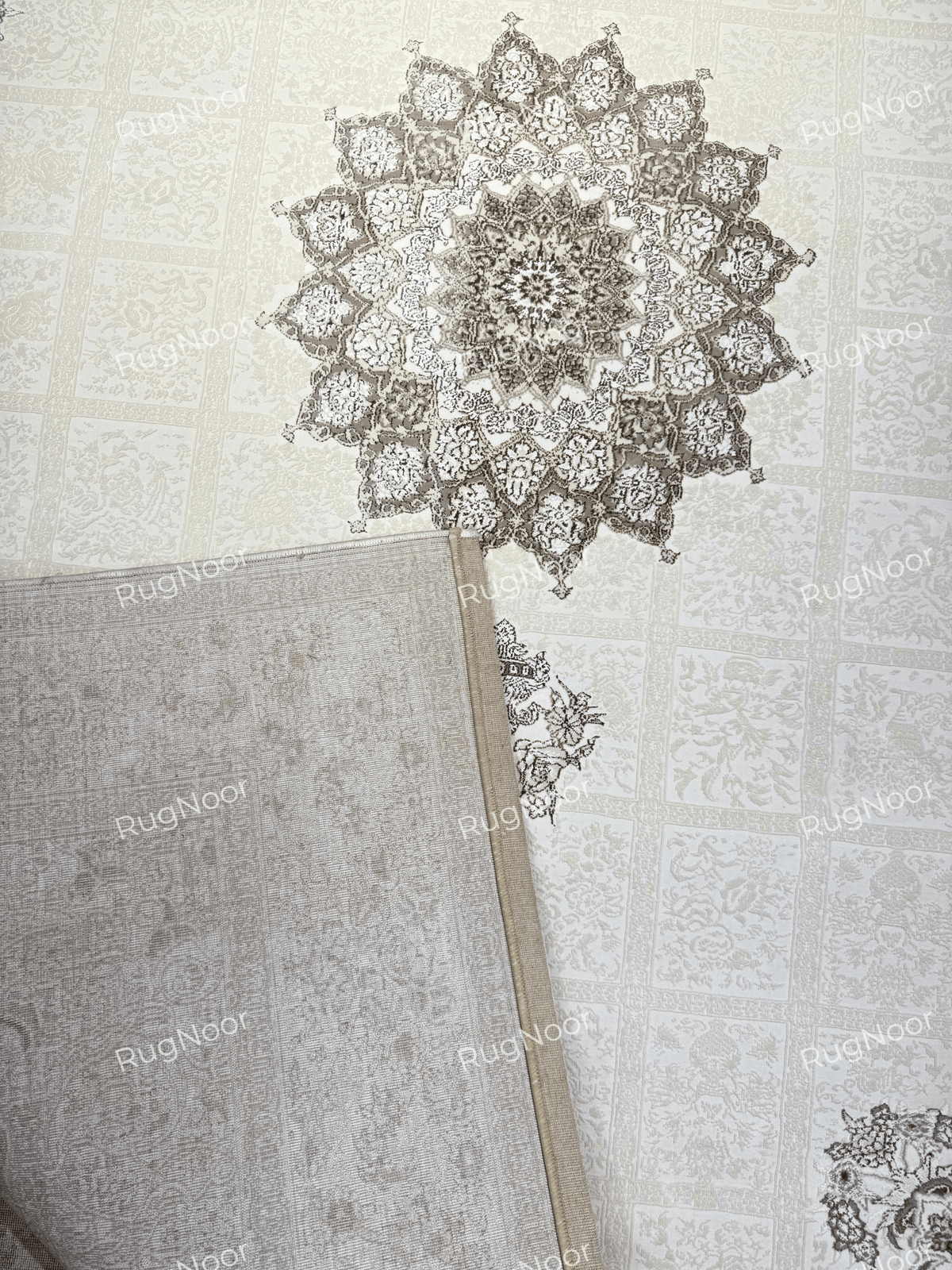 Folded corner of the Parichehr ivory carpet showing its reverse side and patterned front, RugNoor.