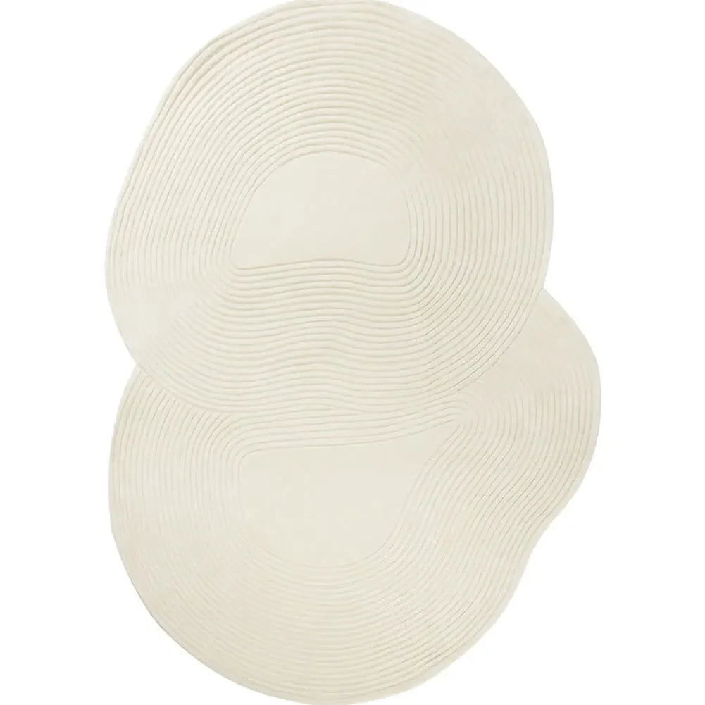 Two overlapping oval-shaped cream-colored woven rugs with concentric wavy patterns, shown on a plain white background.