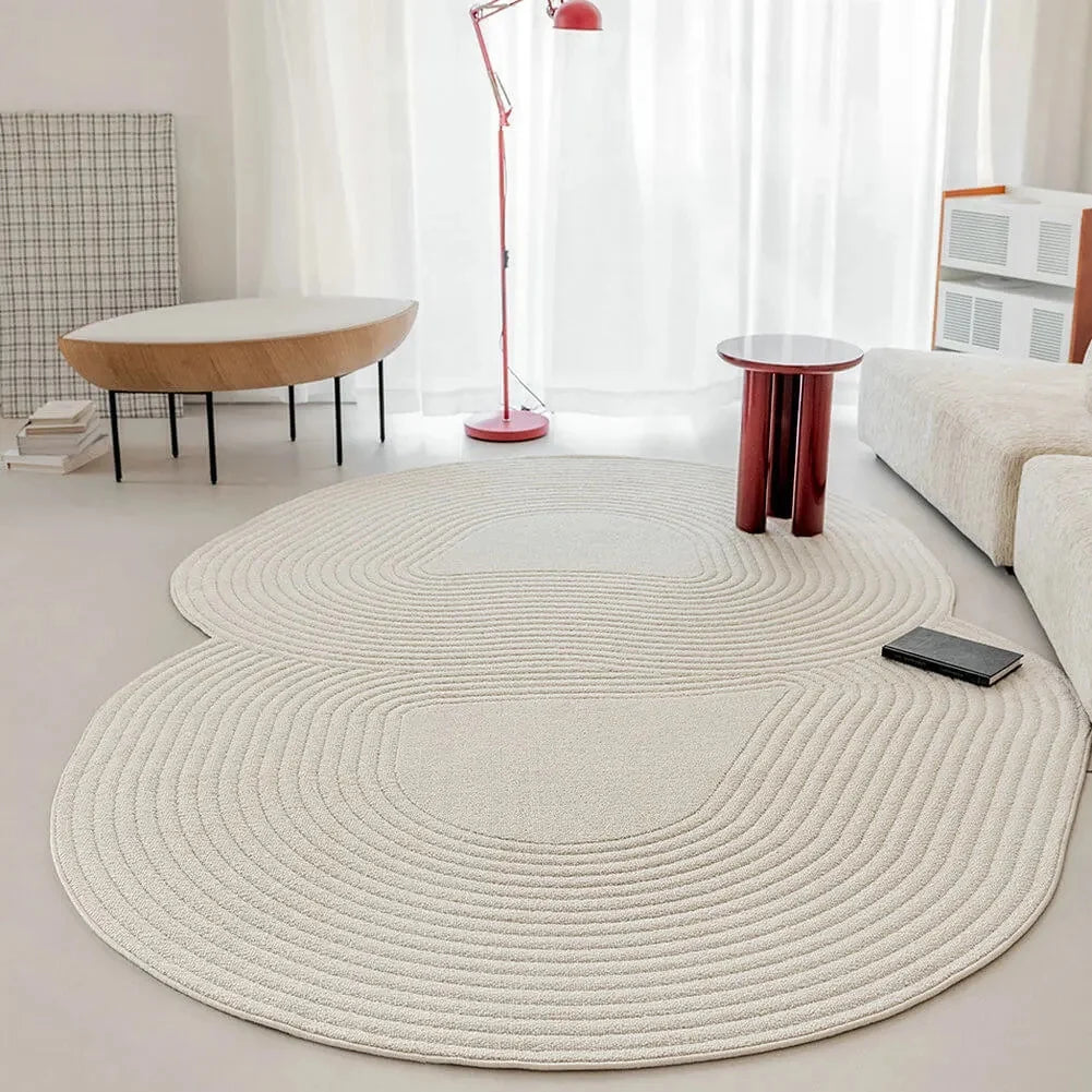 irregular ivory rug in a modern living room with white walls and minimal furniture.
