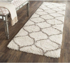 White shaggy rug with brown pattern on a wooden floor