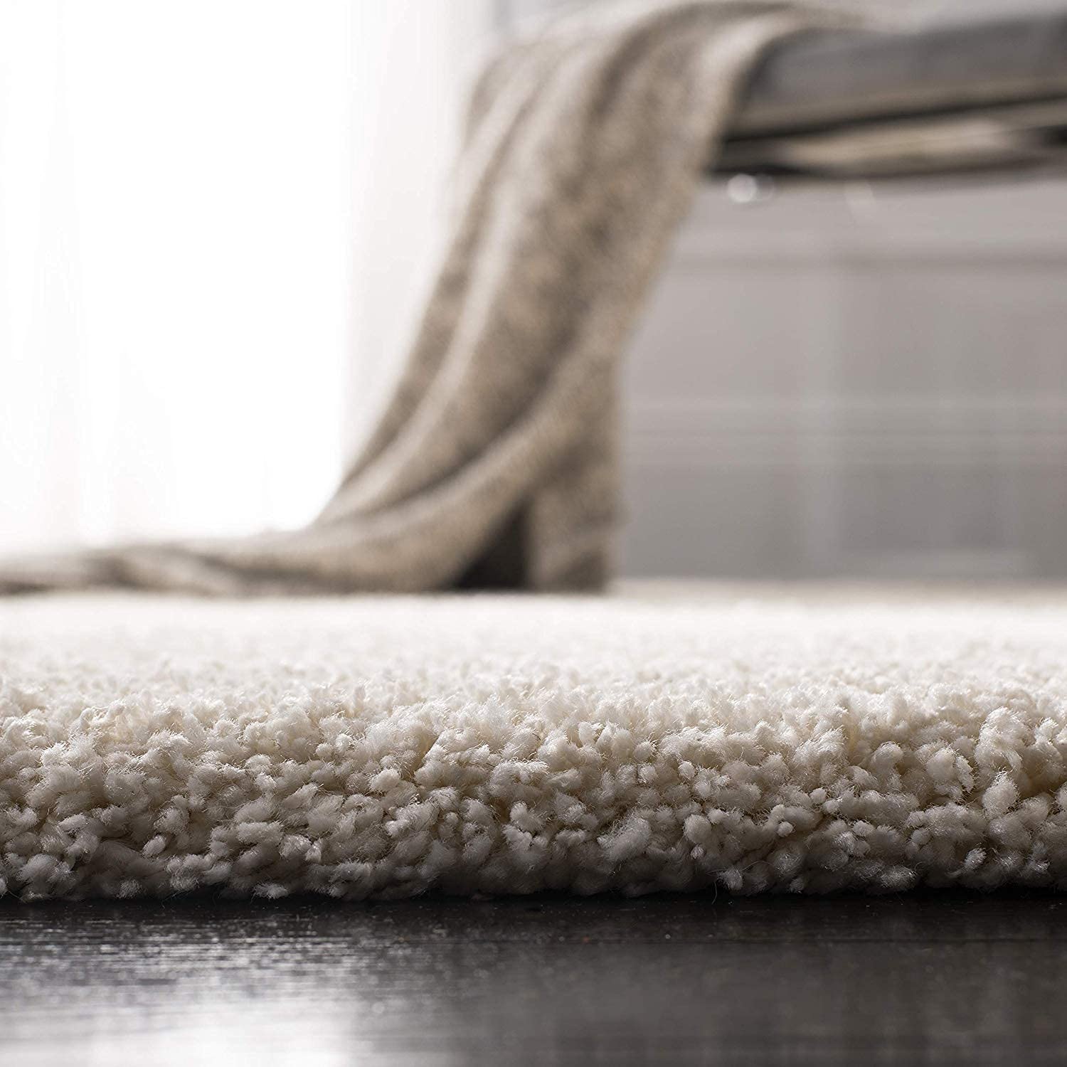 Close-up of a textured beige rug with a blurred background