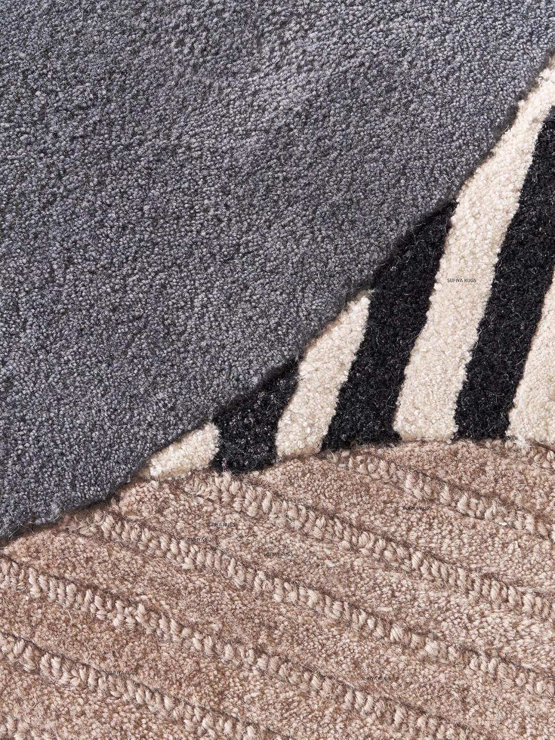 Detailed view of the Noema abstract wool rug featuring layered organic forms in ivory, taupe, charcoal, and black.